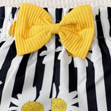 Yellow bow and daisy flowers on a black and white striped baby girl short.