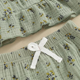 Green textured baby clothes with floral pattern