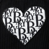 Heart-shaped patch with 'BABY' pattern on a black background