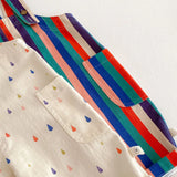 Two baby rompers, one with a dotted pattern and one with colorful stripes