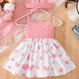Pink baby girl dress with heart pattern.