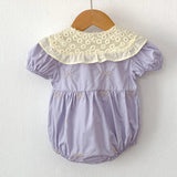 Purple baby romper with floral collar.