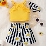 Yellow top and black and white striped shorts with daisy patterns.
