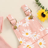 Pink suspender shorts with white daisy pattern.