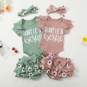 Two baby outfits with 'Auntie's bestie' text, green and pink