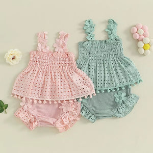 Two baby suits, one pink and one green.