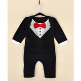Black baby romper with red bow tie and white shirt on a beige background